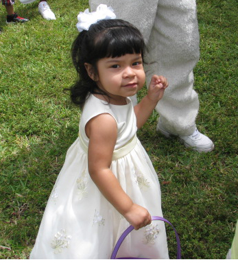 Toddler Alba collecting eggs at Easter egg hunt in Pompano Florida.